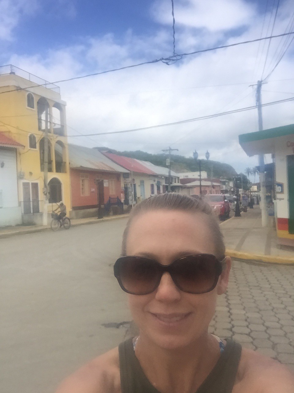 Selfie on the colorful streets of Moyogalpa, Ometepe Island Nicaragua — colonial buildings and volcanic hillside