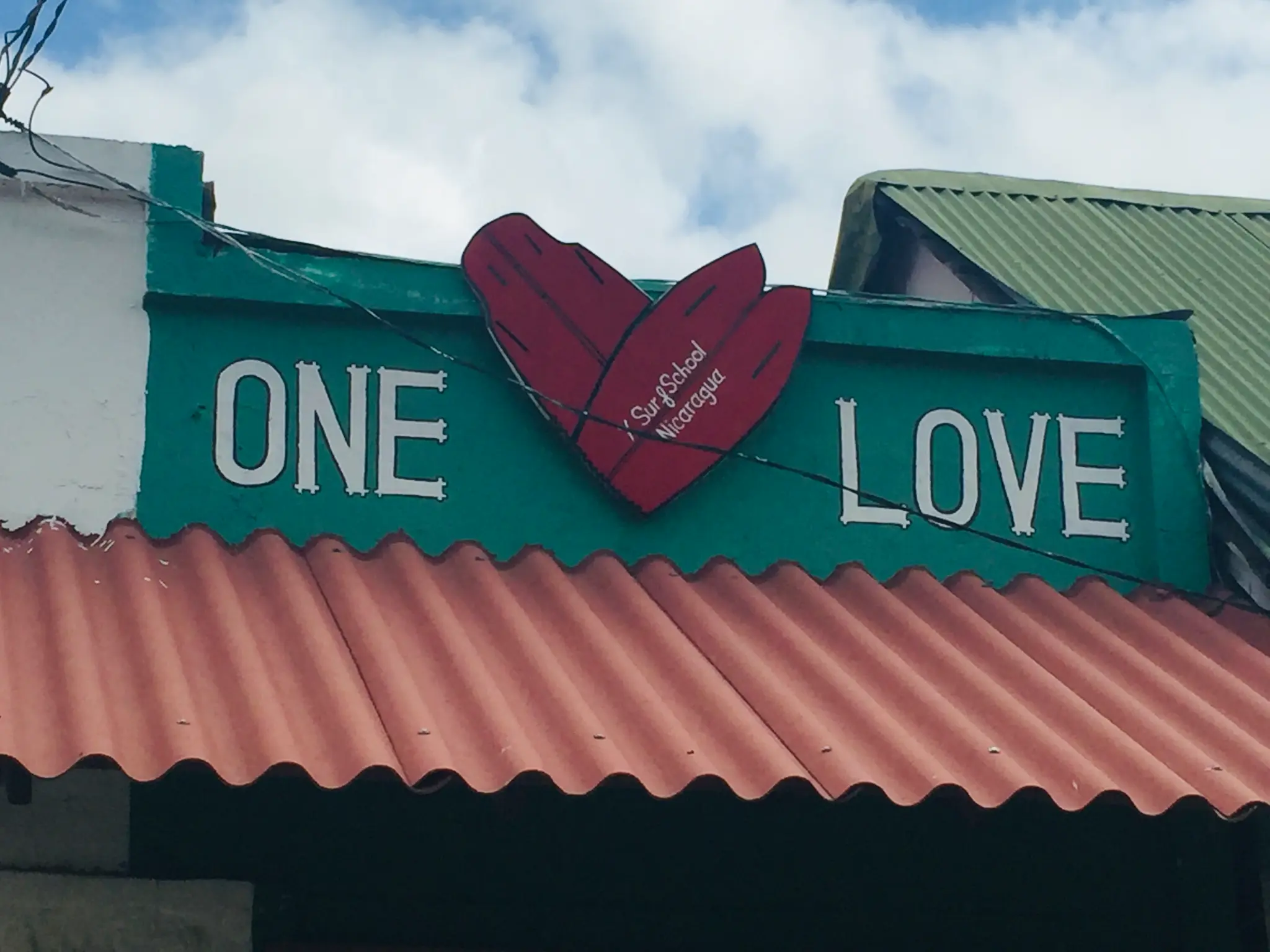 San Juan del Sur beach Nicaragua — the Pacific crescent bay with Toña beer umbrellas and fishing boats