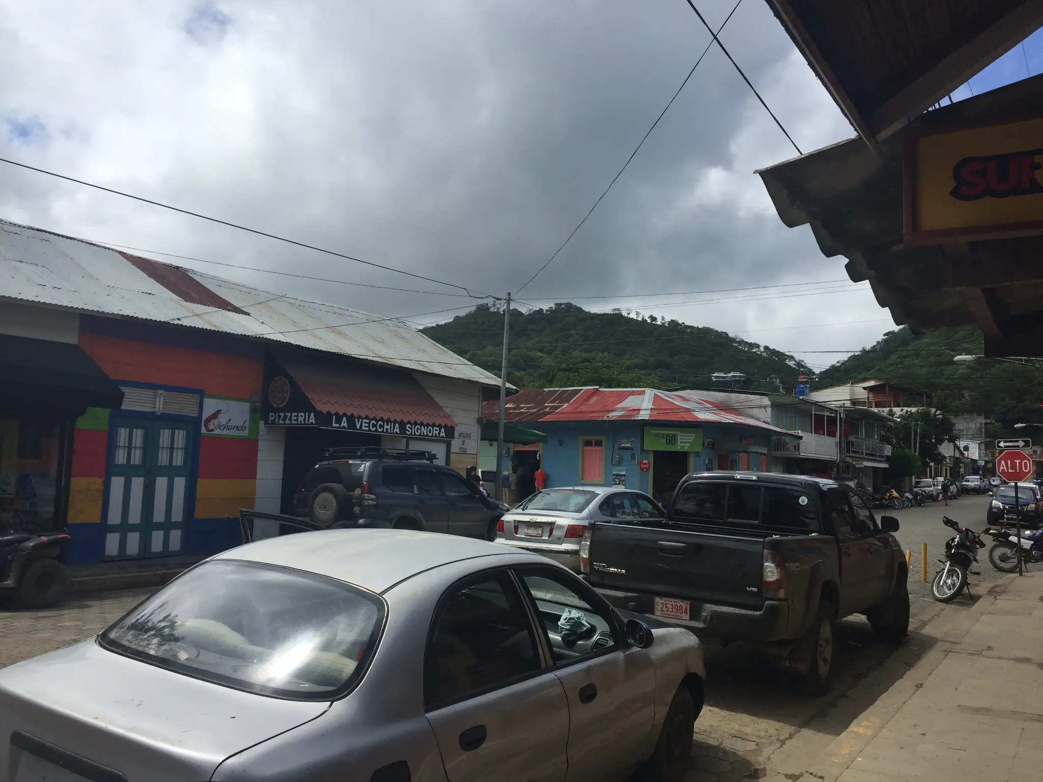 Main street of Moyogalpa, Ometepe Island Nicaragua — colorful buildings and Volcan Concepcion rising behind the town