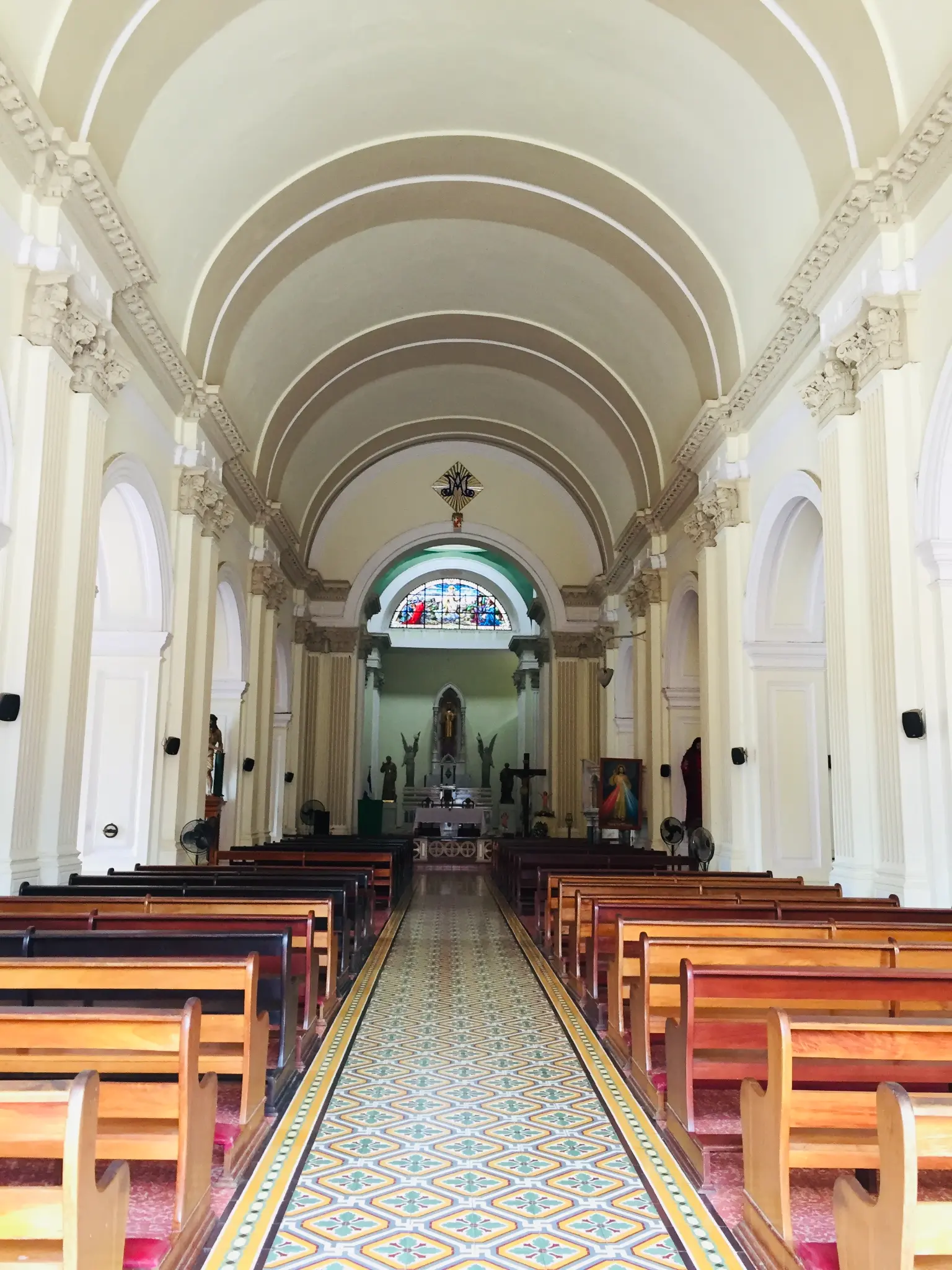 Interior of Granada Cathedral Nicaragua — soaring barrel-vaulted arches and ornate tiled aisle