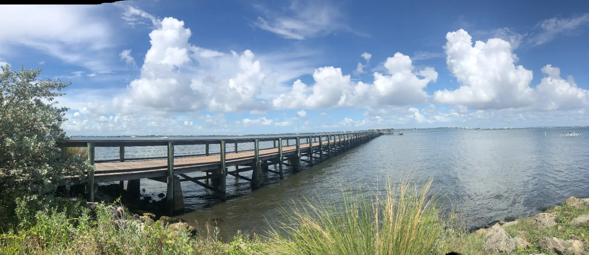Panoramic view of the Ryckman Park fishing pier extending over the Indian River Lagoon, Melbourne Florida