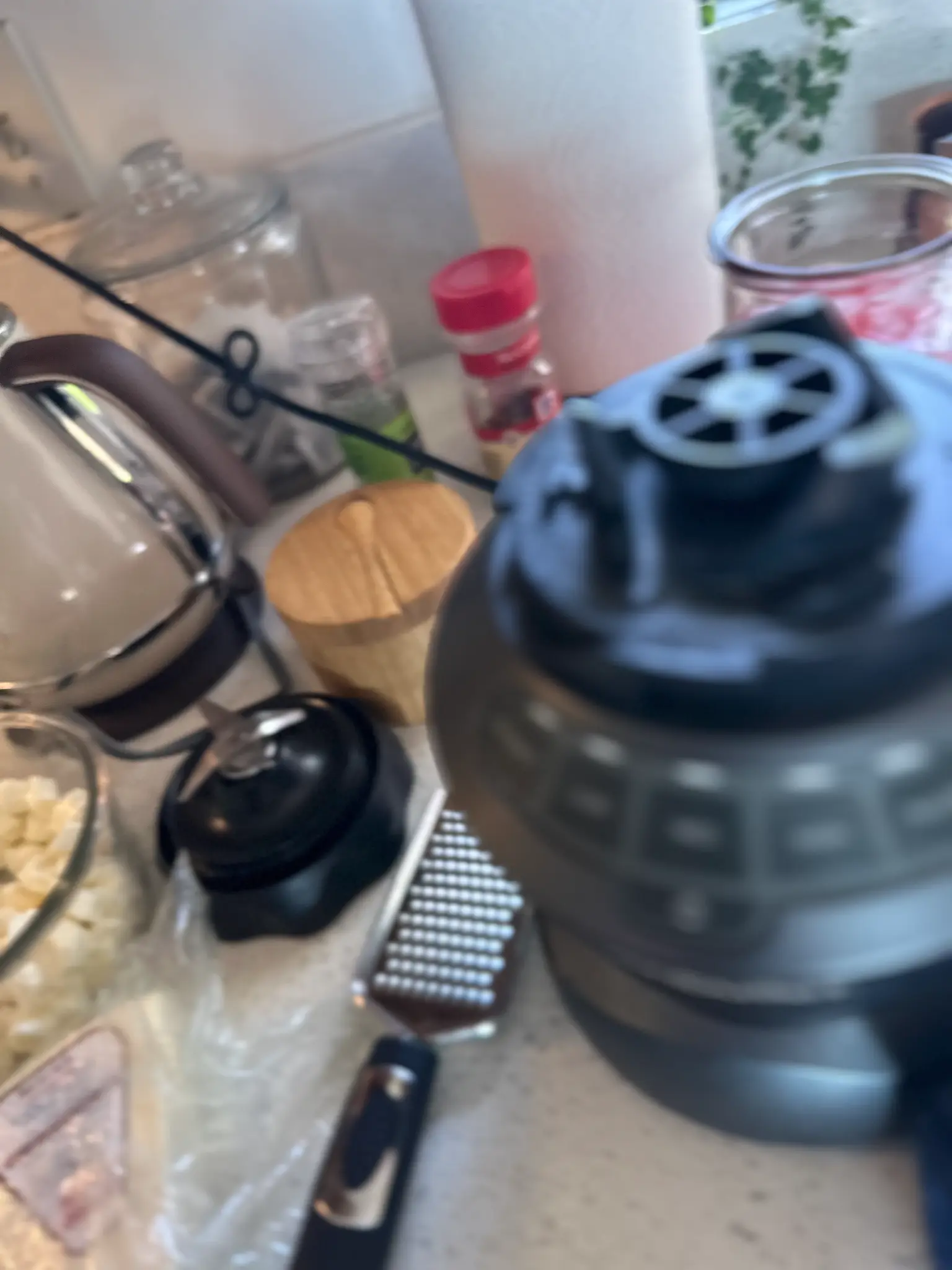 Kitchen counter with blender, grater, spices, and ingredients ready for the mostaccioli recipe