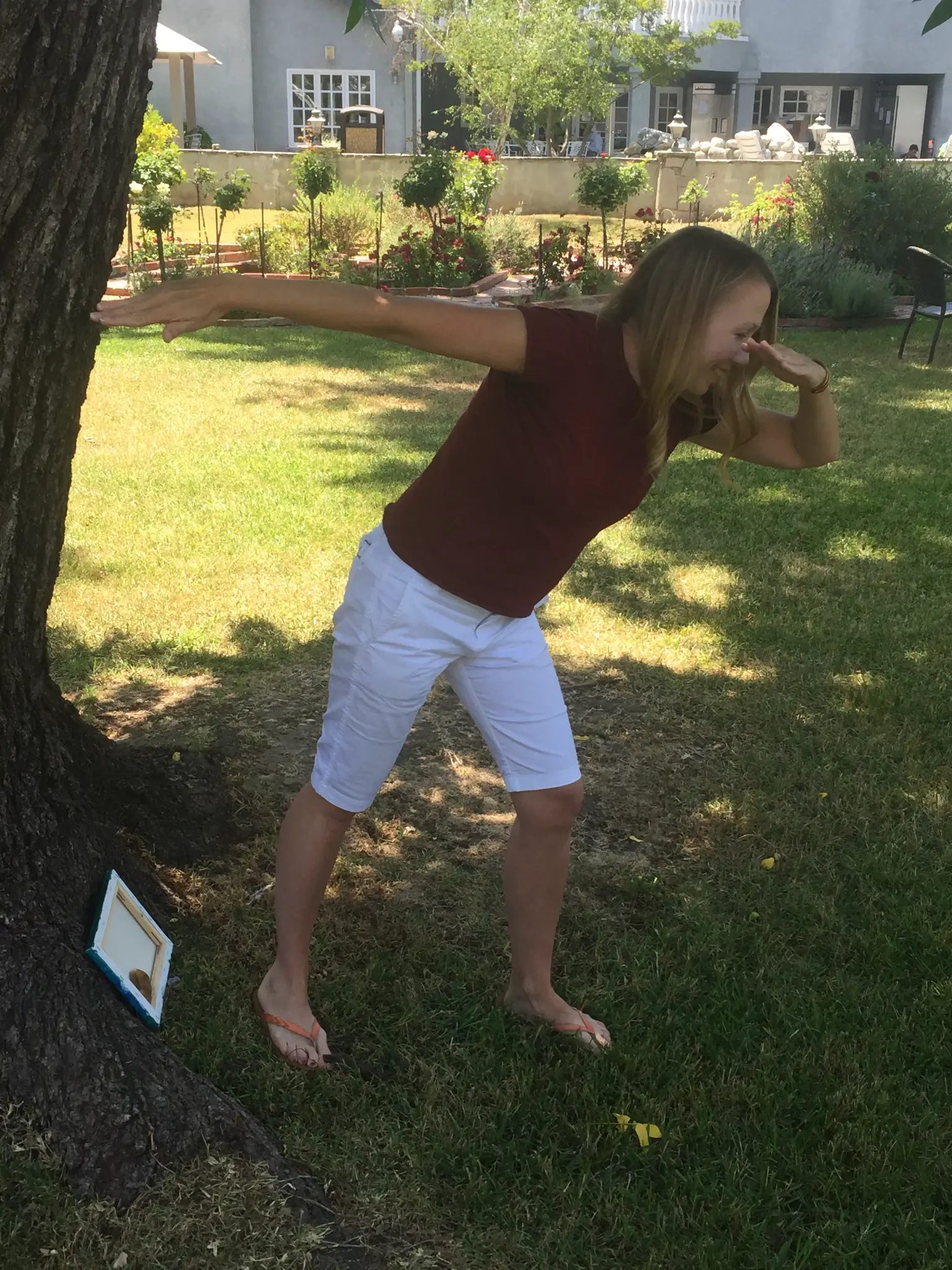 Kristen doing a yoga pose in the treatment garden
