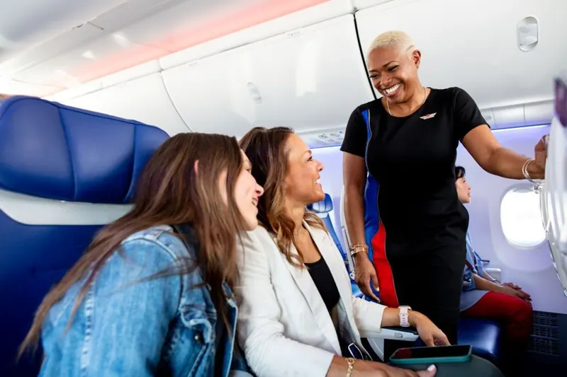Southwest Airlines flight attendant serving women passengers